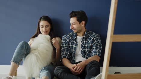 video of couple with dog in their new empty house.