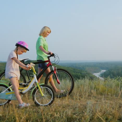 a woman with a child walk near bicycles