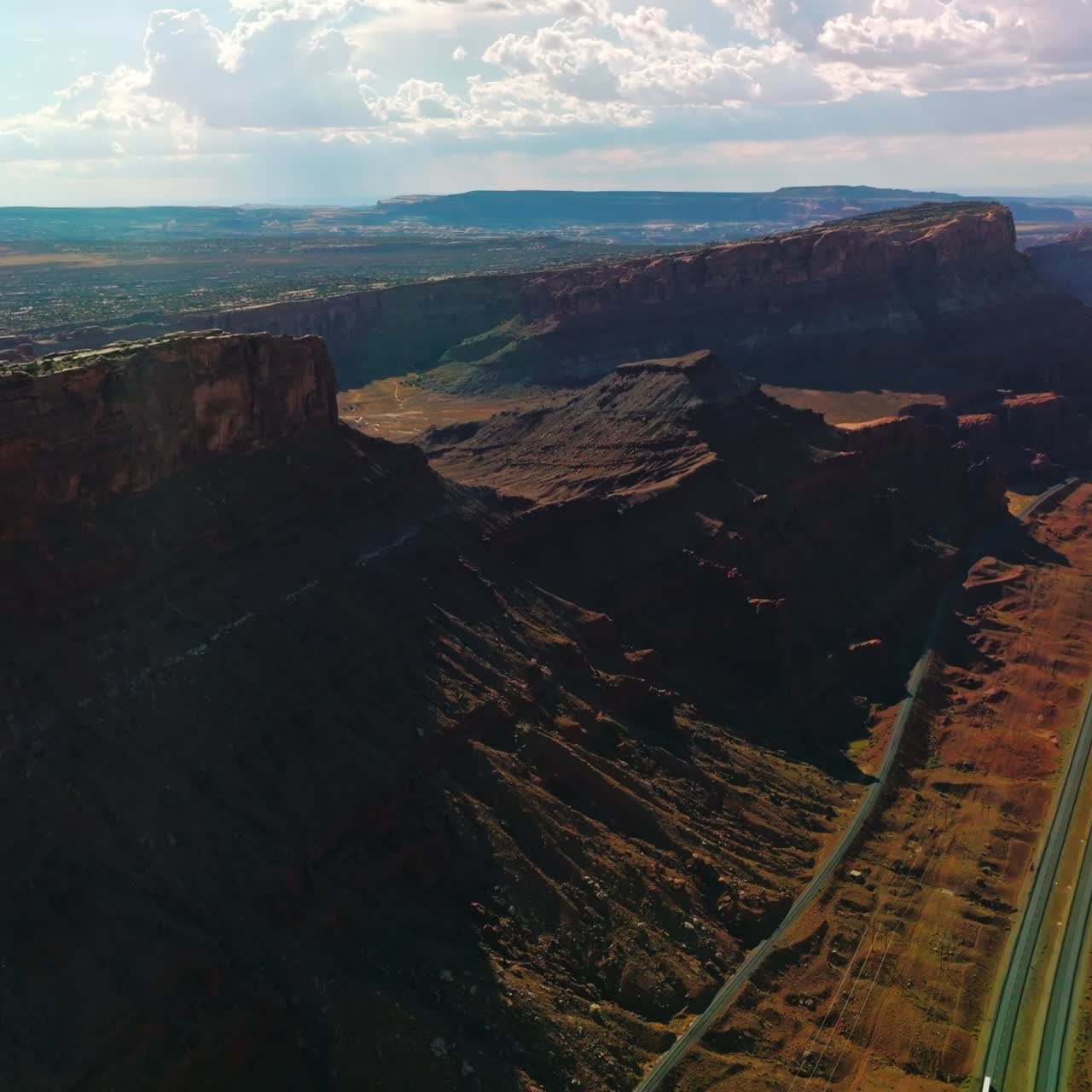 Spectacular view of huge rocks in the national park of Utah, USA. Roads passing through the canyons on sunny hot day. Aerial view