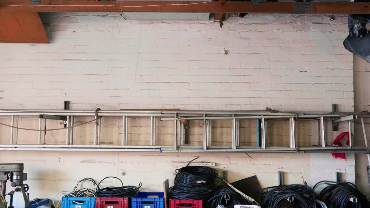 Ladder hanging on wall in Workshop