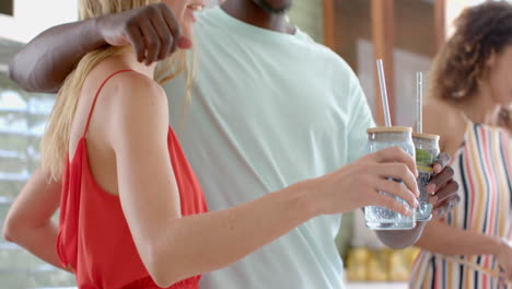 Young-African-American-man-enjoys-a-drink-at-a-social-gathering