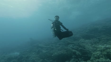 scuba diver floating underwater in budda position in 4k