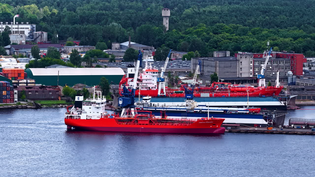 Ship Docked At The Industrial Port Unloading, Loading Cargo. - aerial shot