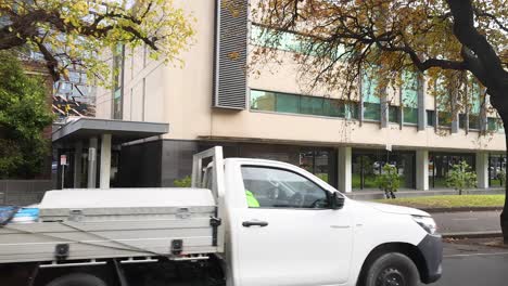 vehicles passing by a city building