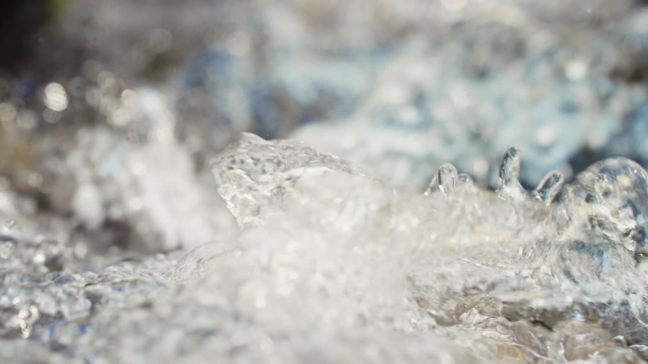 Closeup of water splashing and bubbling in a stream