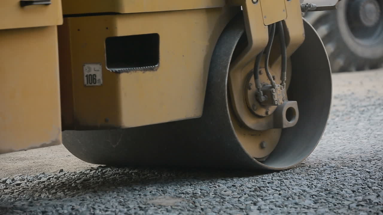 Road roller working on the new road construction site