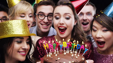 Woman-blowing-out-candles-birthday-party-slow-motion-photo-booth