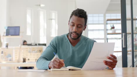 portrait of busy african american businessman having video call in slow motion