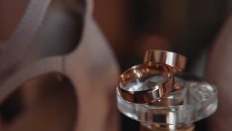 gleam wedding rings on perfume bottle cap extreme closeup