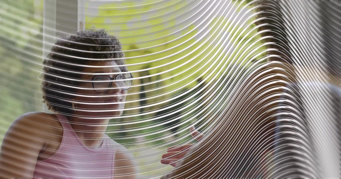 Female colleague listening, shifting behind etched glass partition gesturing in business meeting