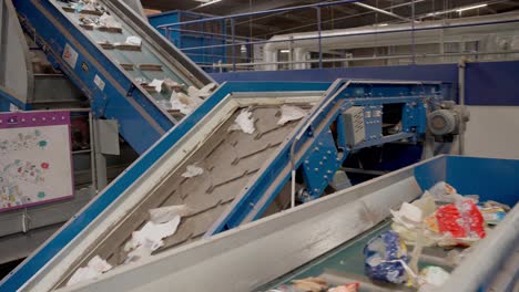 travelling conveyor belt with paper and carton waste materials, transferring the waste to processing site