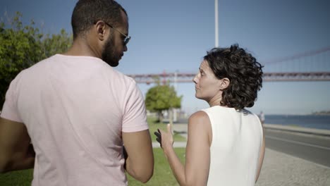 Back-view-of-happy-couple-walking-outdoor