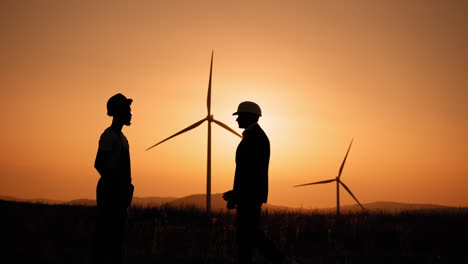 business deal at wind farm sunset