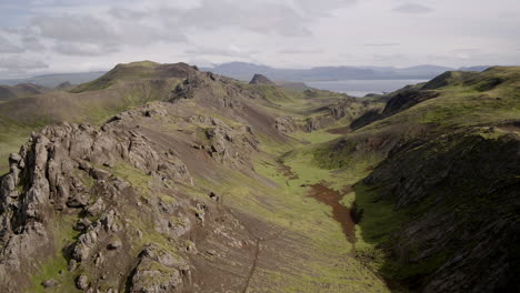 nesjavellir landscape aerials in iceland dropping down behind hills for parallax