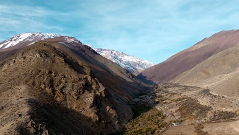 Aerial-View-Of-Settlement-Near-Snowy-Andean-Mountain-Range-In-Northern-Chile