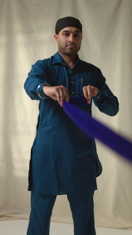 a sikh man wearing a turban and traditional clothing.