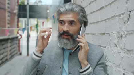 man talking on phone in an alley