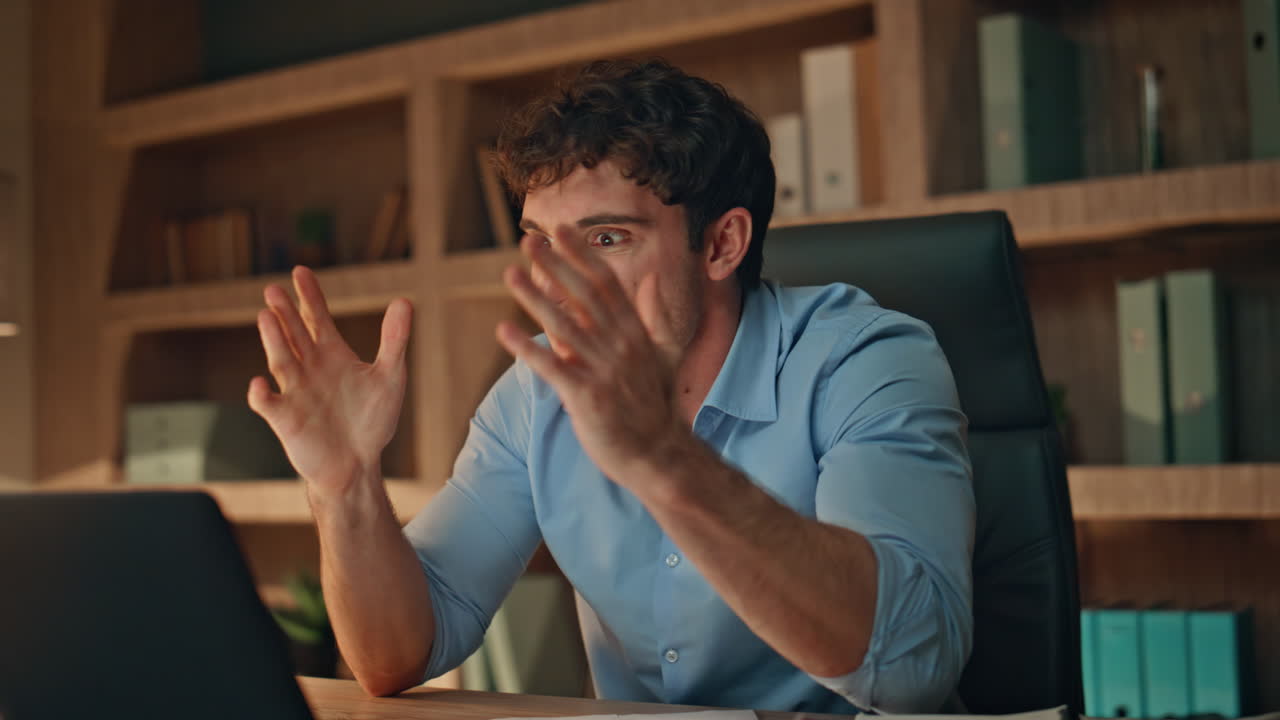 Furious boss shouting video meeting by laptop in dark office closeup. Mad ceo