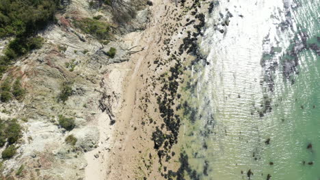 aerial shot of a empty beach with clear water, shot on a bright sunny day