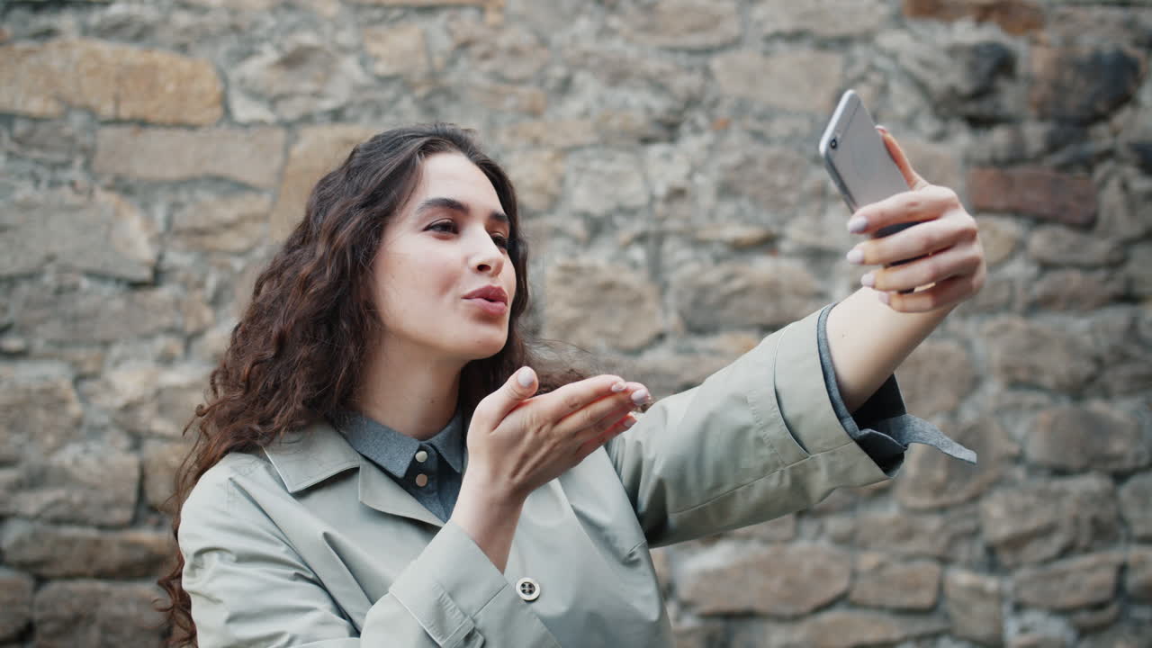 Woman taking a selfie outside