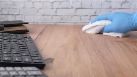 cleaning a desk with gloves