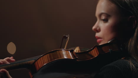 classic music concert in opera house female violinist is playing violin in dark philharmonic hall