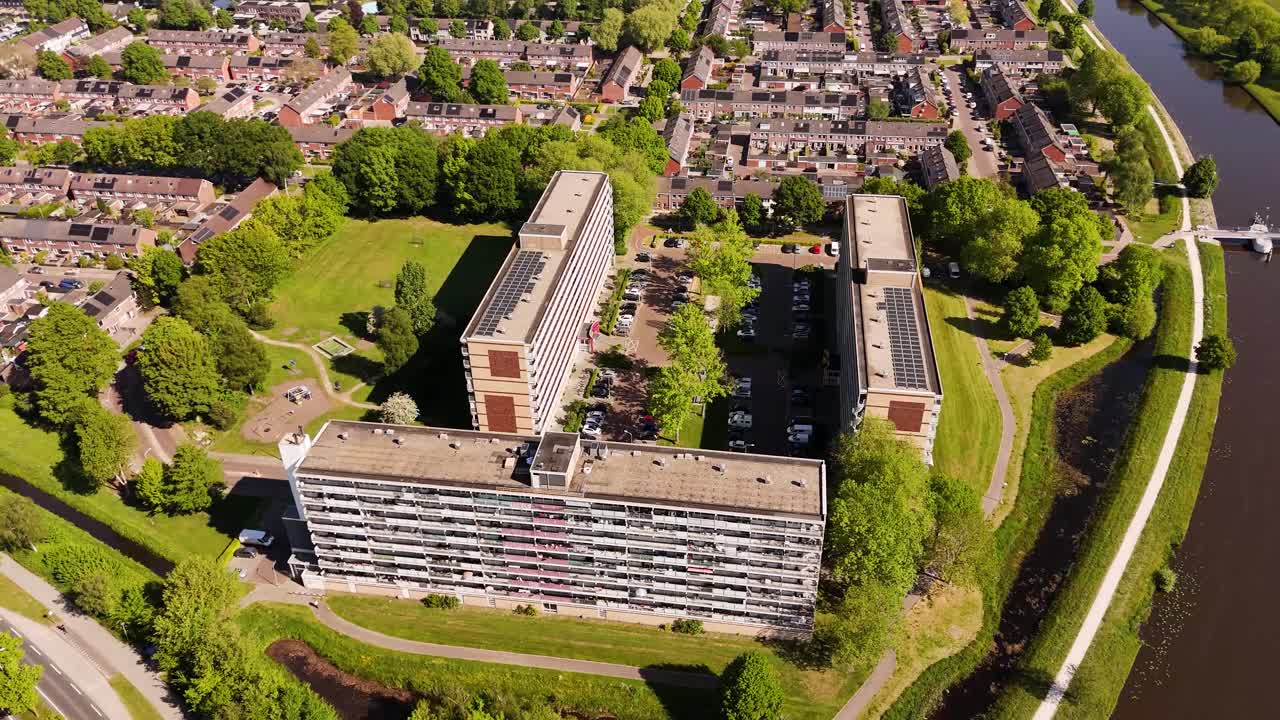 Aerial view of a residential area with apartment buildings and a canal in the Netherlands
