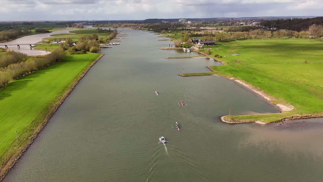 Vista aerea di barche e kayak su un ampio fiume con rive verdi