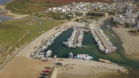 aerial circling over touristic port of torre pali in puglia, italy