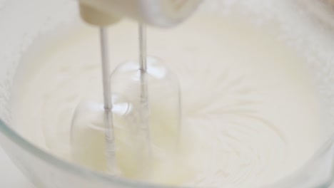 close-up of a mixer whipping a batter