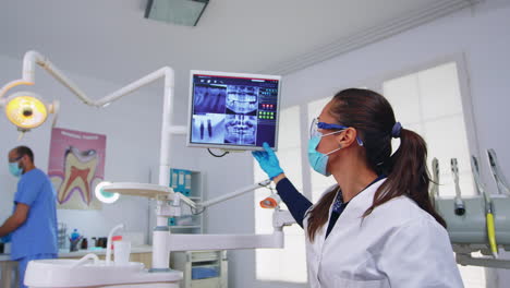 patient pov to dentist showing x-ray on monitor unit