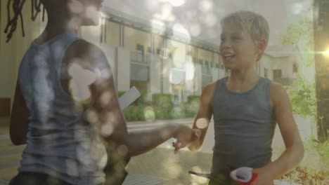 Animation-of-bokeh-sunlight-over-happy-diverse-schoolboys-shaking-hands-after-sports