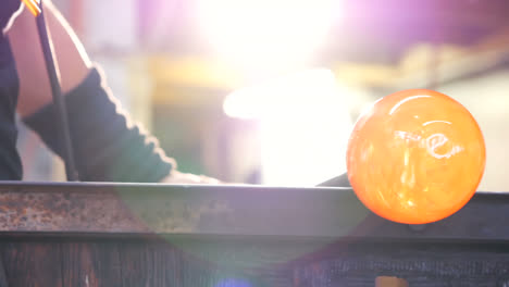 glassblower shaping a molten glass