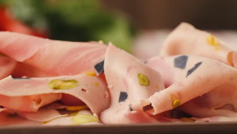 sliced salami with pistachios