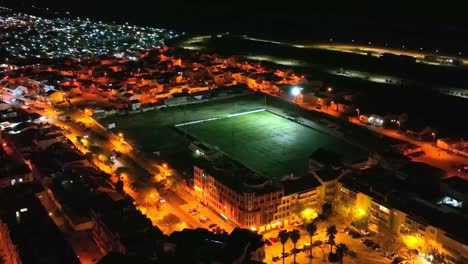 drone footage of soccer field at night in costa da caparica, portugal