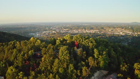 Sunrise-aerial-forward-over-Great-Smoky-Mountains-to-city-Gatlinburg,-USA