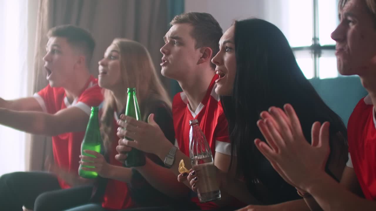Fans at home sitting on the couch watching TV are worried shouting and happy celebrating the victory. Peak of emotions and joy for winning the Euro. World Cup, Olympic games