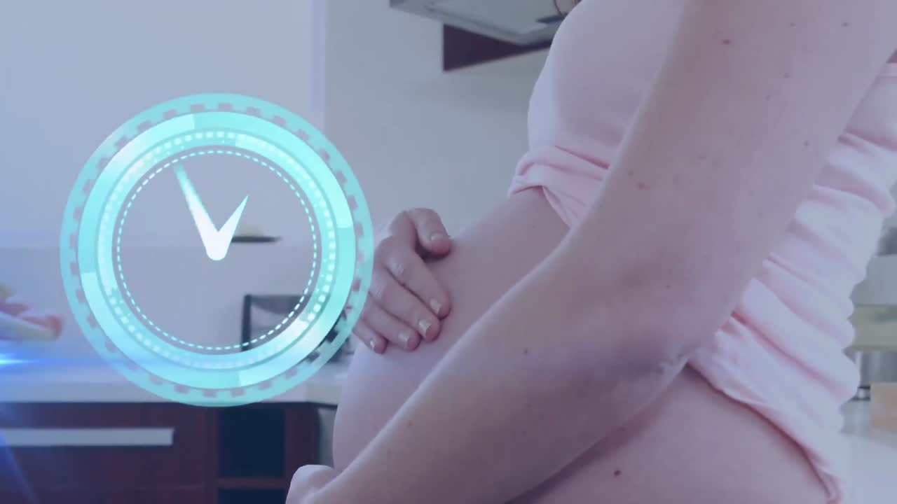 Clock with fast moving hands over happy pregnant caucasian woman in kitchen massaging belly