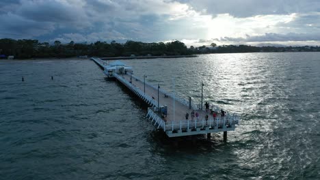 Drone-shot-of-Ocean-Jetty,-camera-slowly-orbiting-around-subject