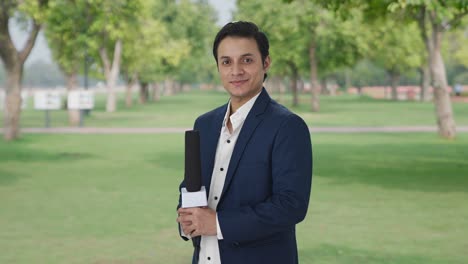 Portrait-of-Happy-Indian-reporter-standing-crossed-hands