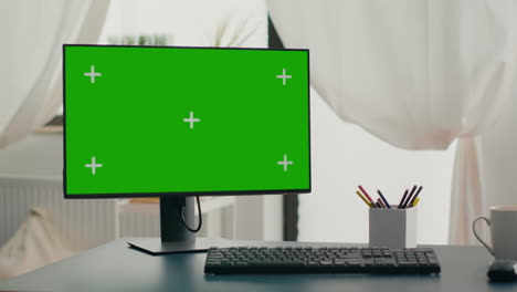 powerful computer with chroma key green screen mock up stands on desk