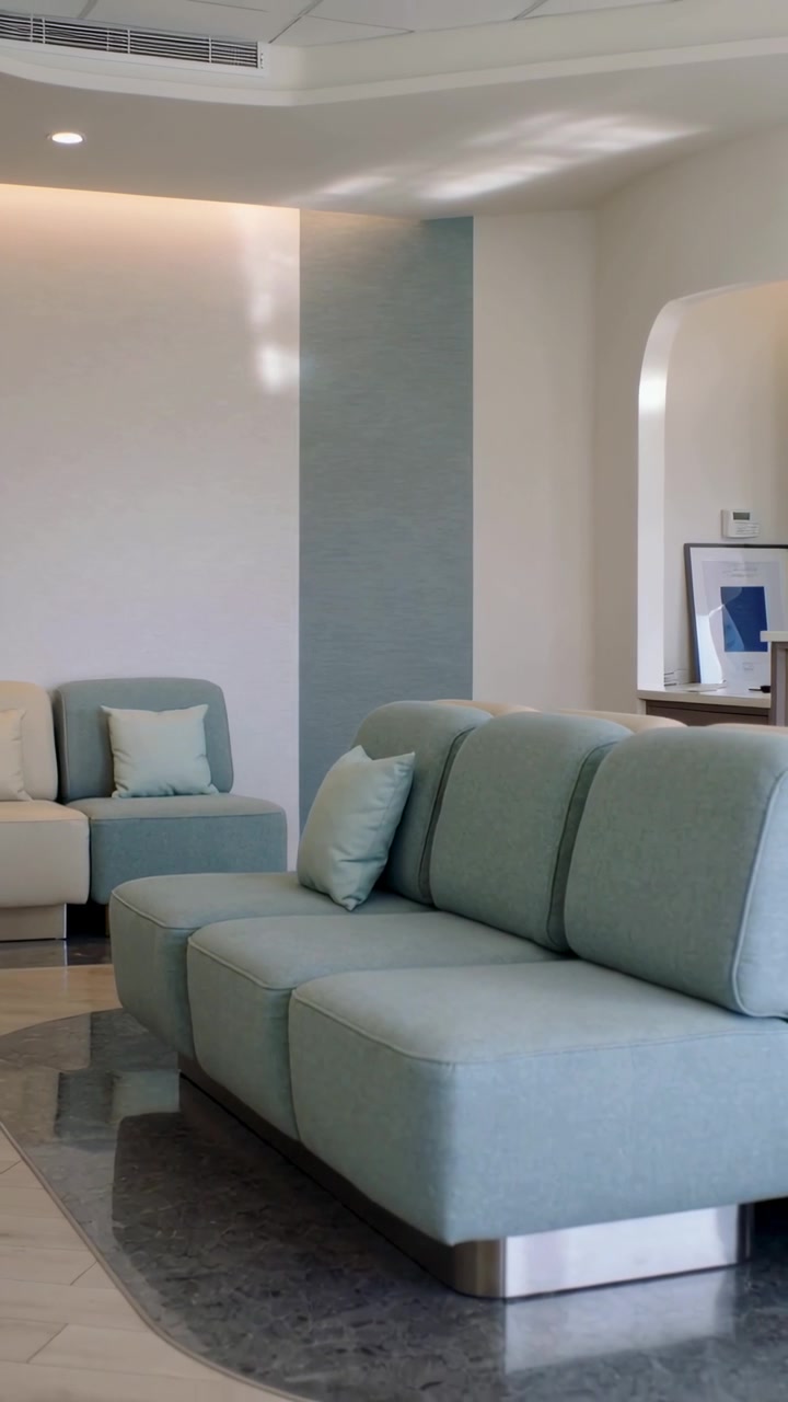 Vertical video: Panning camera starting on shot start, revealing mint sofa with arch and console