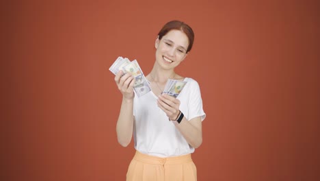 woman counting money looking at camera.