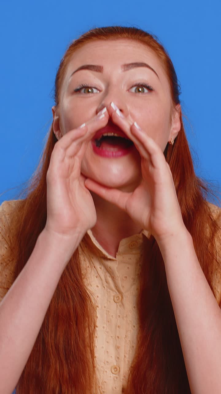 Young woman whisper news rumors holding hands near mouth share gossip quiet keep my secrets
