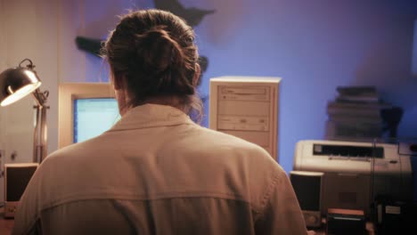 man working and gaming on retro computer pc, it engineer with vintage computer at home, using old fashion technology, close up of retro setup.