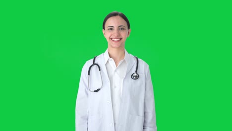 Happy-Indian-female-doctor-putting-stethoscope-on-shoulders-Green-screen