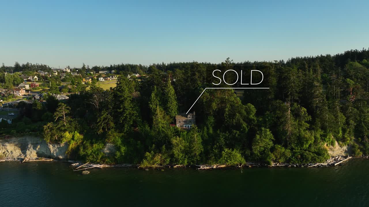 A &amp;quot;SOLD&amp;quot; sign animates over a private waterfront cabin