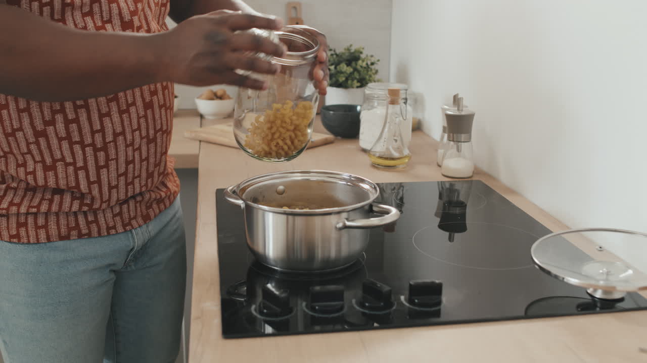African American Man Cooking Pasta at Home
