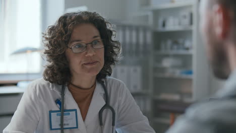 female physician explaining treatment plan to patient in clinic