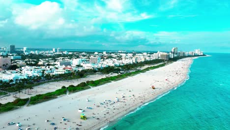 south beach miami florida aerial view flying down the shore of the atlantic ocean on a cloudy day